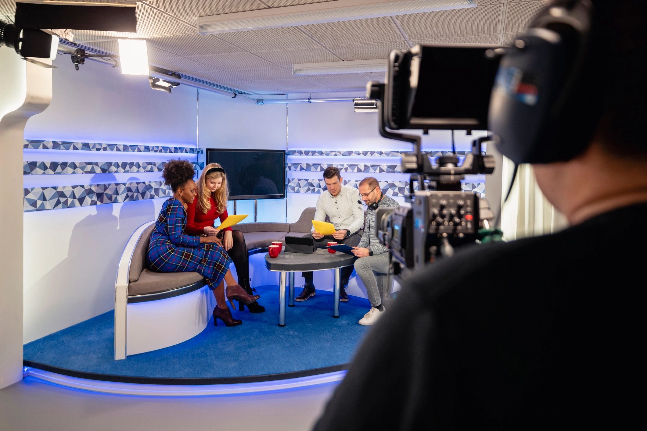 Media production team preparing content in a studio