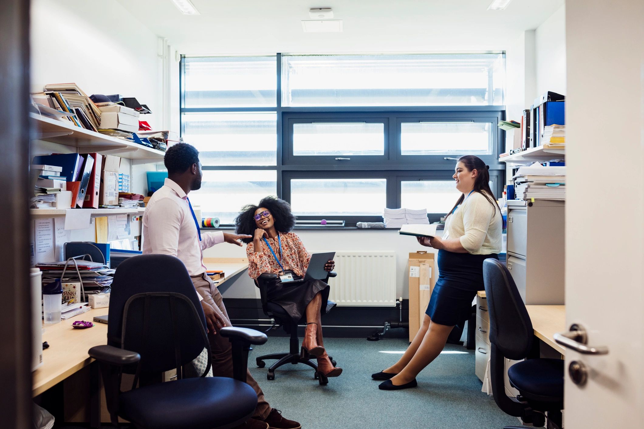 Team discussing current affairs in a collaborative newsroom